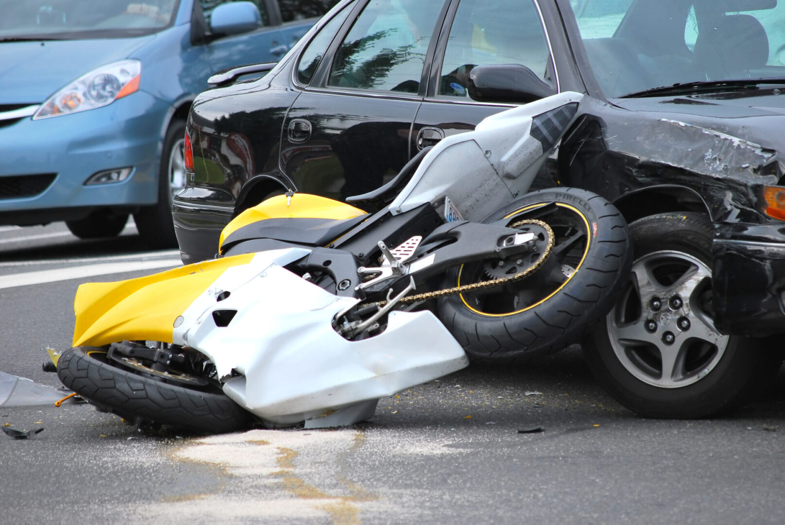 Car and motorcycle accident outdoors.